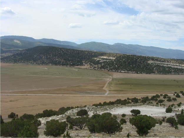 View to the S of the Black Hill cuesta, with the Wasatch Plateau rising in the background.  Black Hill is geographically larger than White Hill, but it is only slightly higher, with an elevation of 6,402 ft.  Black Hill's perfect dip slope of the Green River Formation is shown off in this photo.
