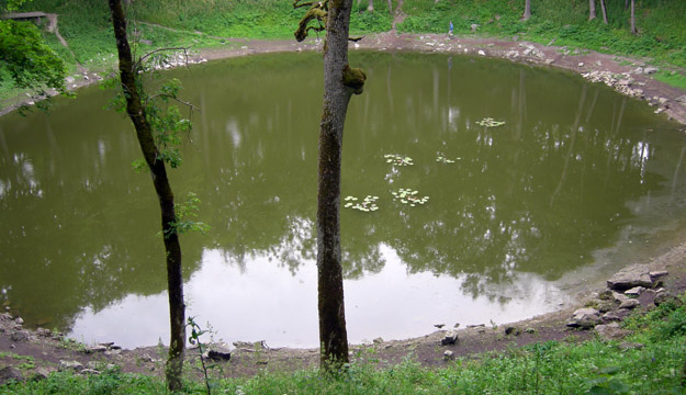 The main Kalli meteorite crater.  On the far side of the pond you may see a spot of blue.  That is Rob McConnell performing his job as a scale very well.