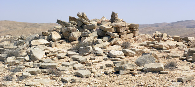A Bronze Age tumulus (rock-covered grave) at the top of a hill north of Makhtesh Ramon.