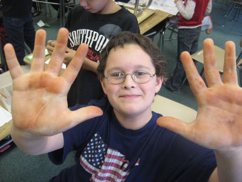 This 3rd grader extends the concept of the streak test to coving his entire two hands in hematite.