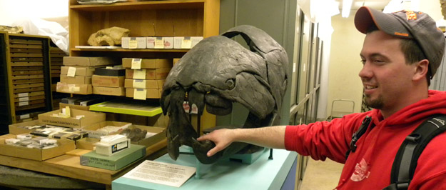Geology Club president Rob Lydell tests the reactions of a Devonian Dunkleosteus fish. They were very slow.
