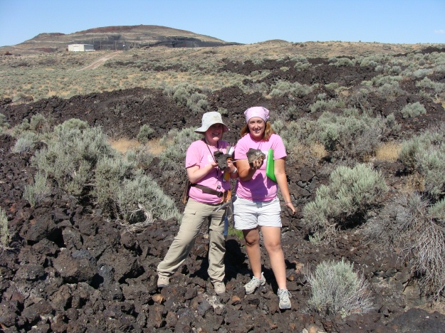Elyssa Krivicich (left, '09) and Elizabeth Deering (right) proudly display the Utah basalt.  The Red Dome cinder cone is in the background.  Hey Dr. Pollock and Becky Alcorn (our Icelandic Team)...do you like it?