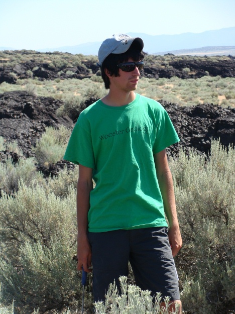 Jesse Davenport, studious as ever, is listening intently to a lecture on the Ice Springs Volcanic Field.  The rough, brecciated aa of the field is behind him.