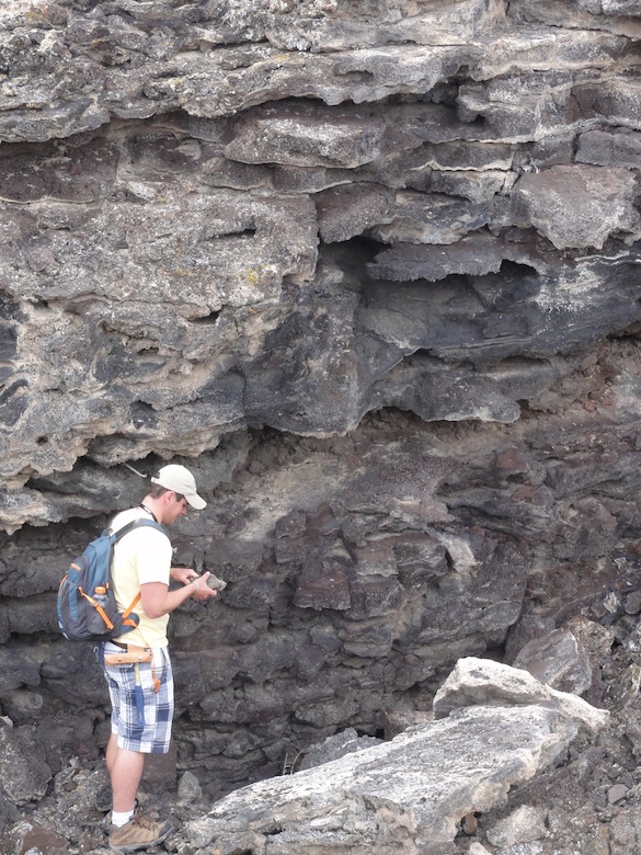 Ben Hinks ('14, Albion) examines a stack of thin pahoehoe flows in his field area. Credit: M. Pollock