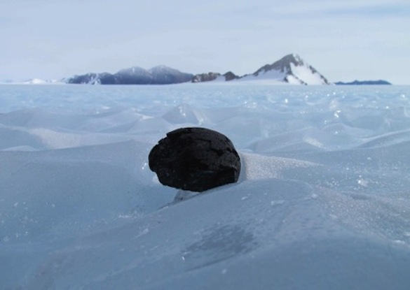 Image of meteorite, exhibiting fusion crust, in Antarctica.  Photo from: https://earthandsolarsystem.wordpress.com/2013/01/21/ansmet-meteorite-hunting-2012-2013-season-draws-to-an-close/  